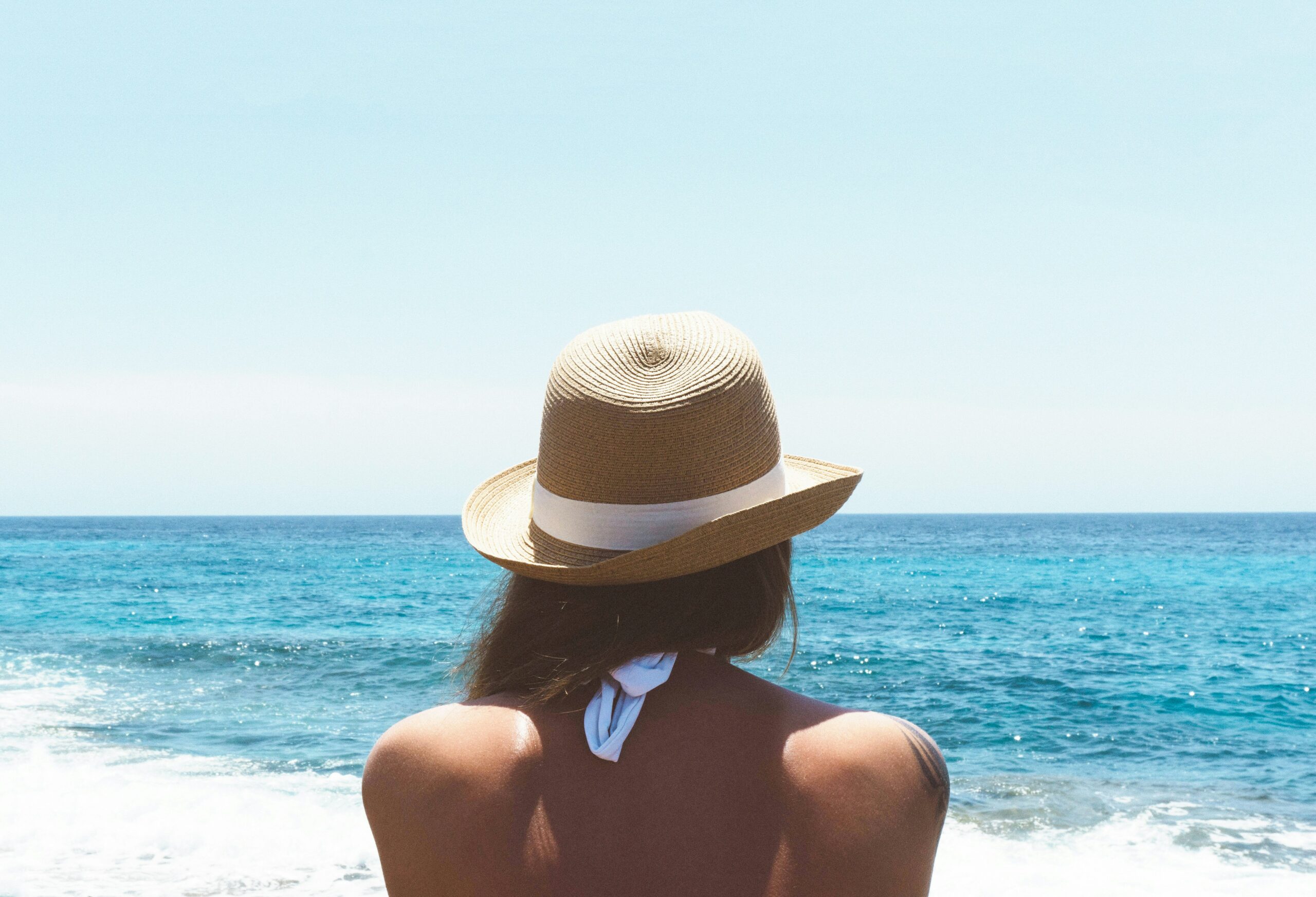 woman on beach in hat