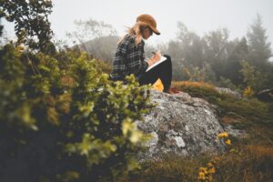 Woman journaling quietly, reflecting on the root-cause healing process